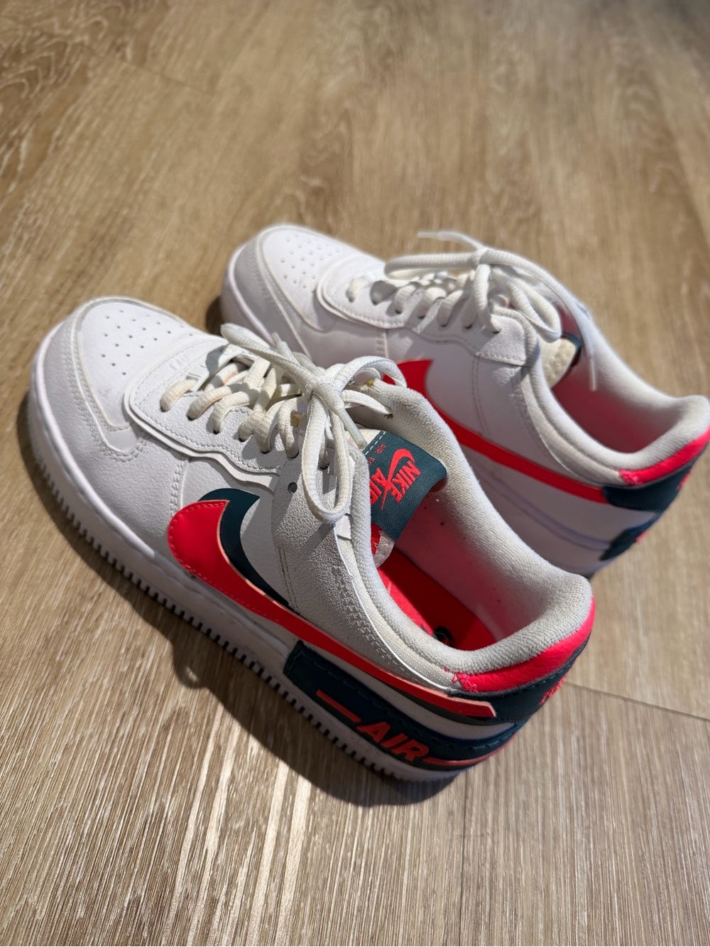 Nike Air Force 1 sneakers in white with pink and blue accents